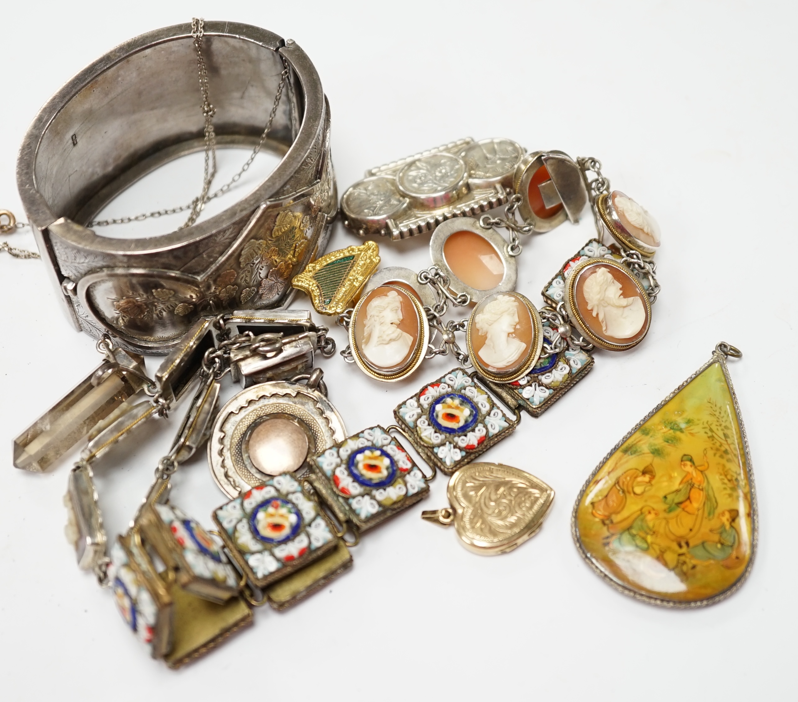 Assorted Victorian and later jewellery including a late Victorian three colour yellow metal and silver bangle, a white metal brooch with aesthetic engraved decoration, cameo mother of pearl and shell bracelets, micro mos